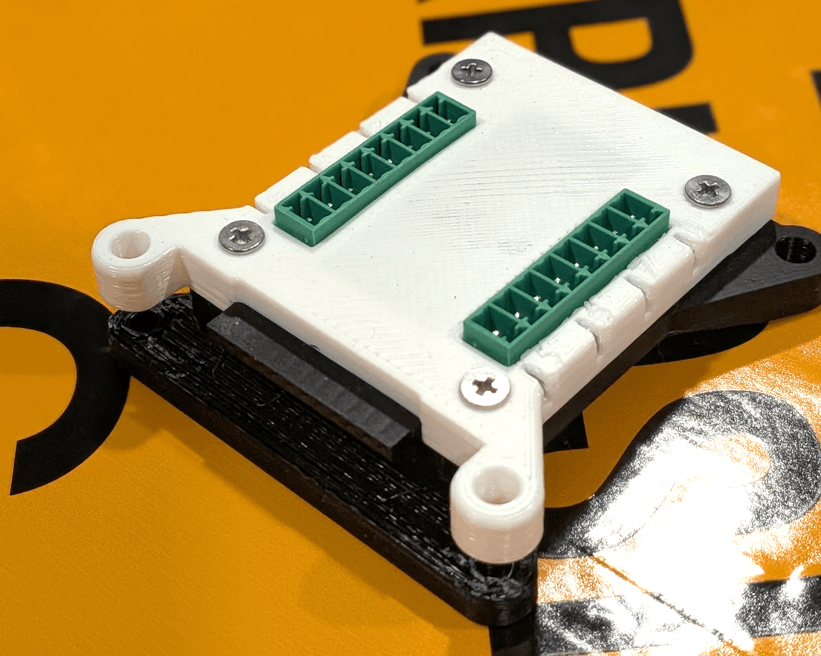 A single 8-cue module from above showing the two rows of green terminal blocks