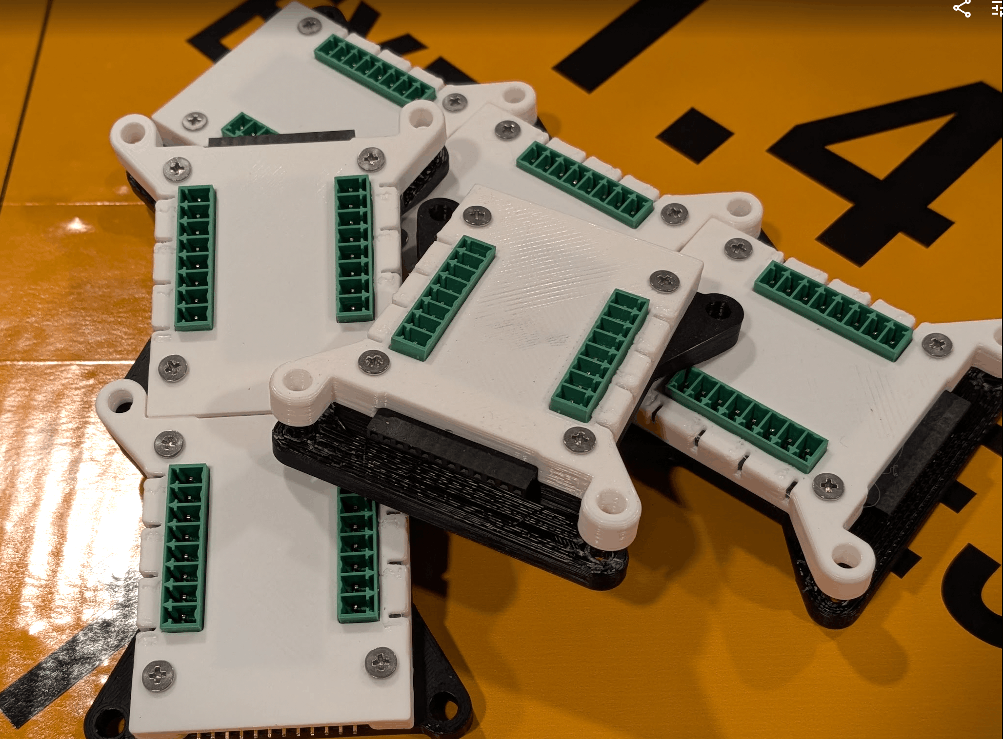 A loose pile of finished 8-cue modules on a workbench