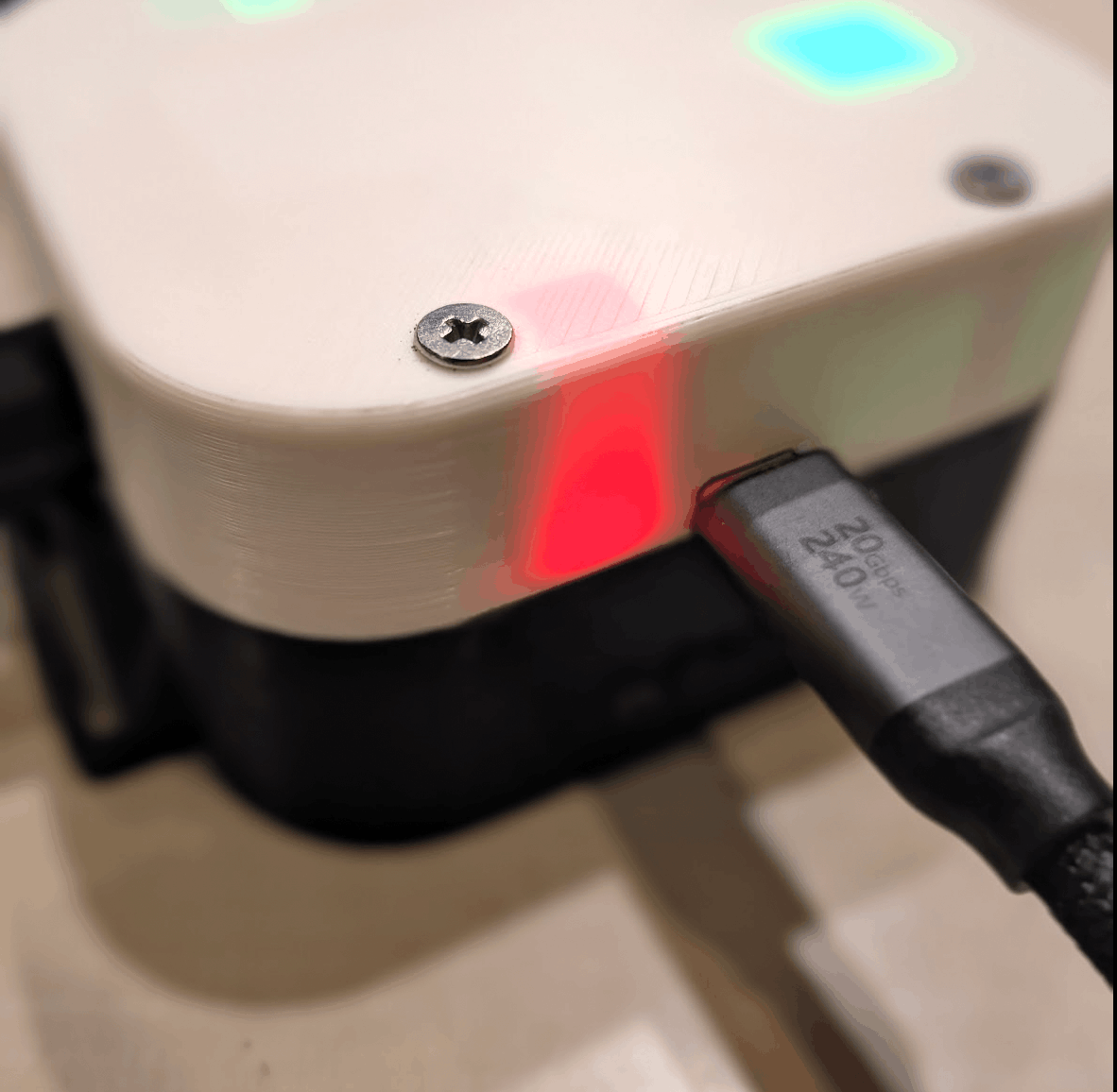 Receiver charging via a USB-C PD cable, red status LED visible through the enclosure